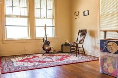 Sitting room with wood finished floors and basebo