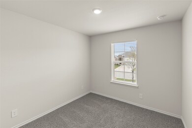 Carpeted empty room with baseboards
