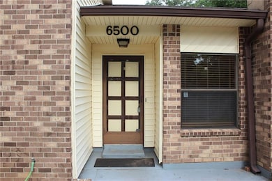 Property entrance featuring brick siding