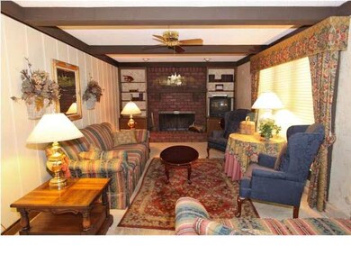 Family room with wooden beams, built in bookshelve