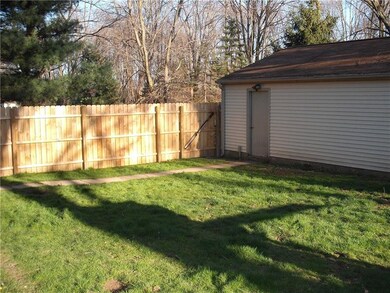 Fenced in backyard leading to man door on double c