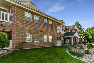 View of front facade featuring a front lawn and a balcony