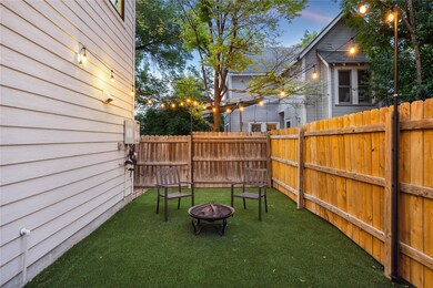 Yard at dusk featuring a fire pit and a fenced ba