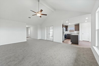 Unfurnished living room featuring light colored carpet, beam ceiling, high vaulted ceiling, a ceiling fan, and recessed lighting