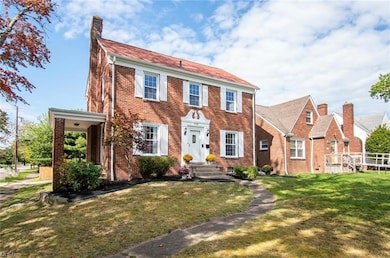 Colonial-style house with a front yard