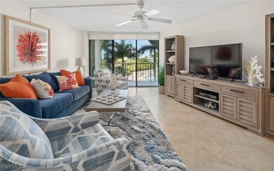 Living room featuring light tile patterned floors and ceiling fan