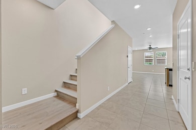 Staircase with tile patterned floors, recessed lighting, and a ceiling fan