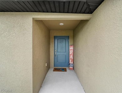 Doorway to property with stucco siding