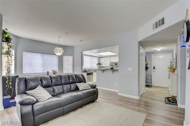 Living room featuring a notable chandelier, sink,