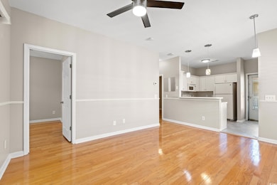 Unfurnished living room with a ceiling fan and light wood-type flooring
