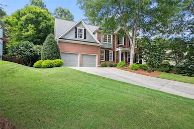 Traditional-style house with brick siding and driveway