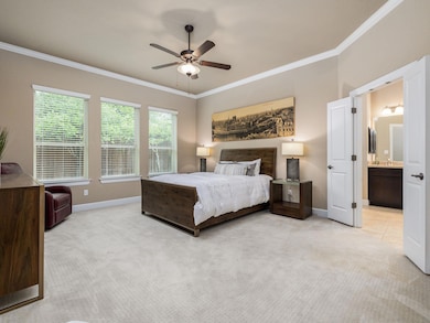 Bedroom featuring baseboards, ornamental molding,