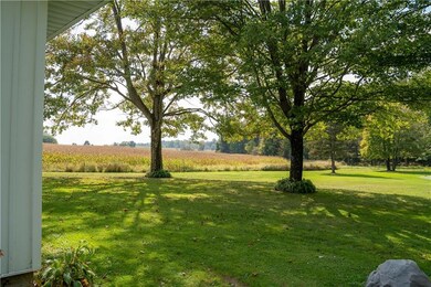 Mature trees and perennials complement the landsca