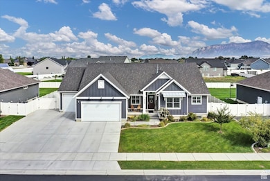 View of front of property featuring board and batten siding, roof with shingles, concrete driveway, a residential view, and an attached garage