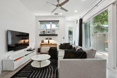 Living area featuring ceiling fan and recessed li