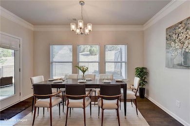 Dining space with dark wood-style floors, baseboar