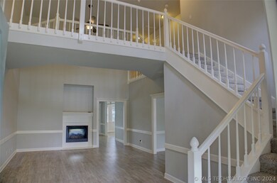 Large living area with a pretty staircase that giv