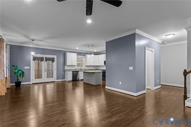 Unfurnished living room featuring crown molding, recessed lighting, french doors, dark wood-type flooring, and ceiling fan