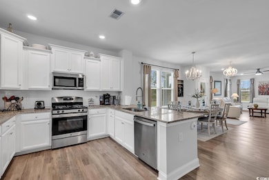 Kitchen featuring white cabinetry, sink, plenty of