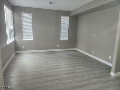 Spare room featuring baseboards, wood finished flo