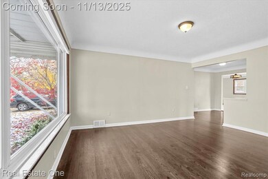 Empty room featuring dark wood finished floors and baseboards
