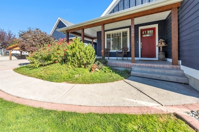 Doorway to property with board and batten siding and a porch