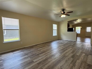Unfurnished living room with arched walkways, cei