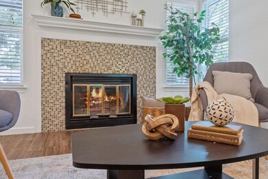 Living area with a tiled fireplace, wood finished