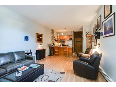 Open plan living space with accent walls and bar s