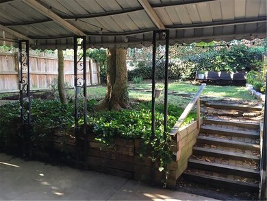 Concrete covered patio and fenced in yard is perfe