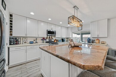 Kitchen featuring a kitchen bar, a center island,