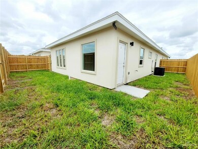 Back of house with stucco siding and a fenced backyard