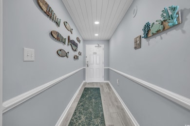 Entryway with recessed lighting, light wood-type flooring, and wooden ceiling