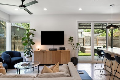 Living area featuring a ceiling fan, recessed lig