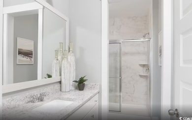 Full bathroom with vanity and a marble finish shower