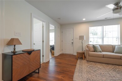 Living room with dark wood-type flooring and ceili