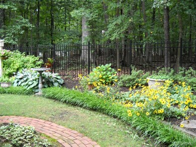Brick path winds through landscaped area (lot goes