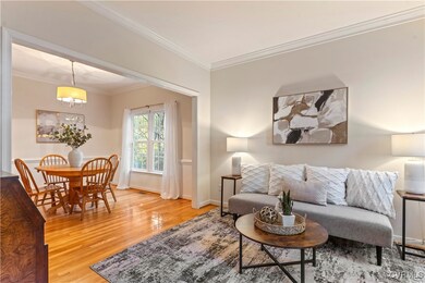 Living room featuring ornamental molding and wood-
