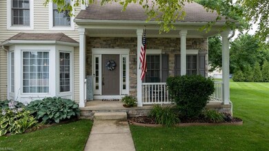 Lovely front porch.  This home has stone siding.