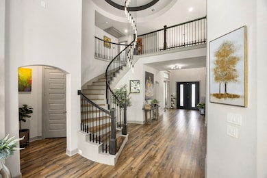 Grand double-door entry with soaring ceilings and