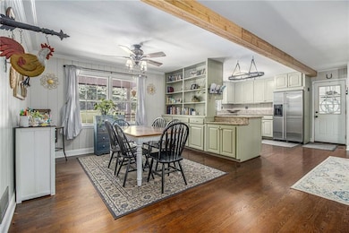 Open Dining room with built-in cabinets & bookcases.