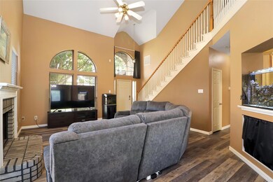 Living room featuring a fireplace, ceiling fan, da