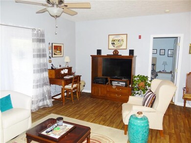 Living room with new flooring and ceiling fan