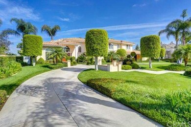 Circular driveway and entry of manicured property.