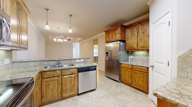 Kitchen with a sink, a peninsula, tasteful backspl