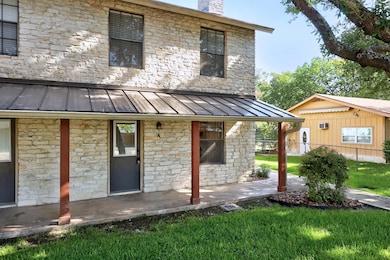 Back of house featuring a standing seam roof, sto