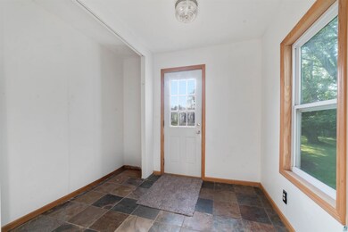 Unfurnished room featuring dark tile patterned flo