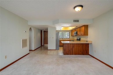 Living room looking toward front door and kitchen