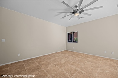 Spare room with baseboards, visible vents, and cei