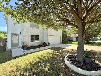 View of front of house with brick siding, an atta